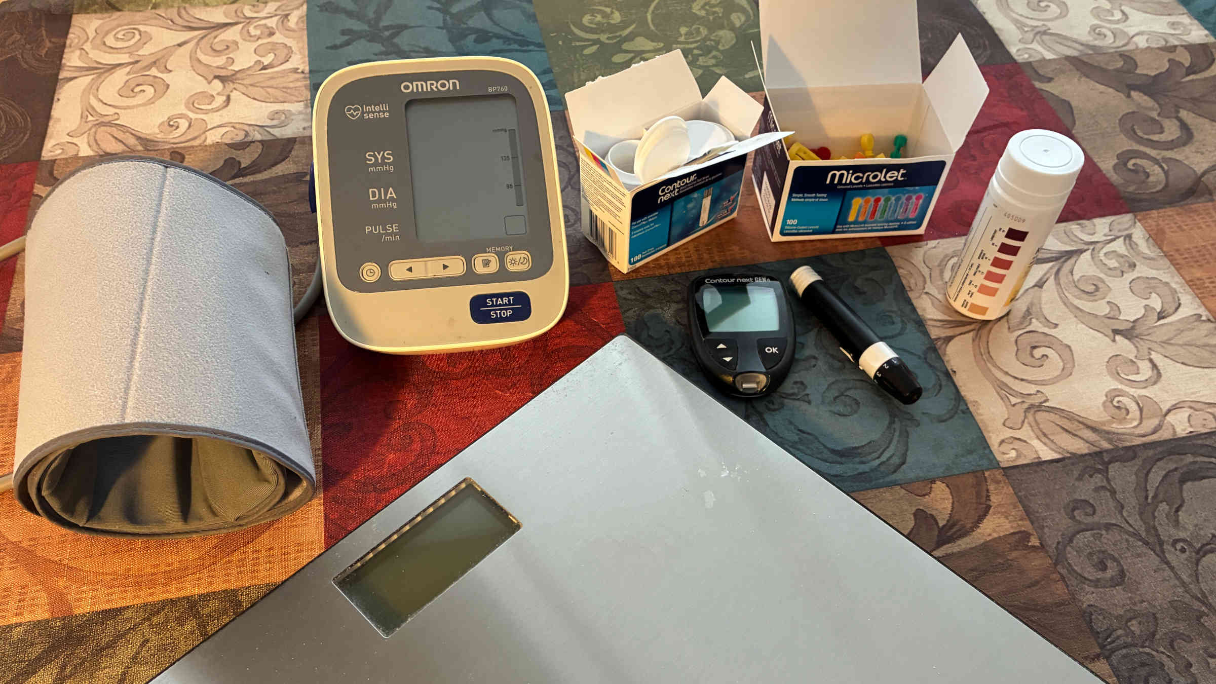 Blood pressure meter, blood sugar testing kit, ketone urinalysis strips, and bathroom scales